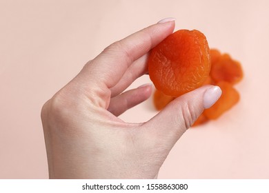 Handful Of Dried Apricots. Woman Holding Dried Apricots.