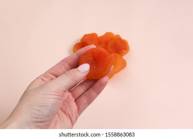 Handful Of Dried Apricots. Woman Holding Dried Apricots.