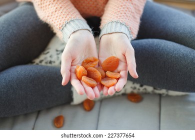 Handful Of Dried Apricots. Woman Holding Dried Apricots.