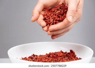 Handful of dried goji berries, gray background. - Powered by Shutterstock