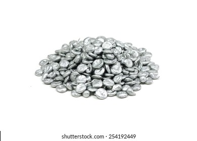 a handful of granular zinc on a white background