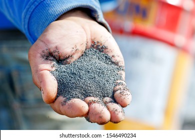 A handful of sand (basalt) grits for sandblasting or abrasive blasting of metal surfaces.