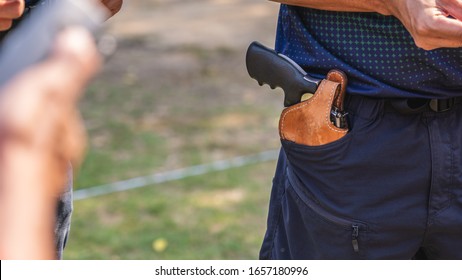 handgun in gun holster in man pocket