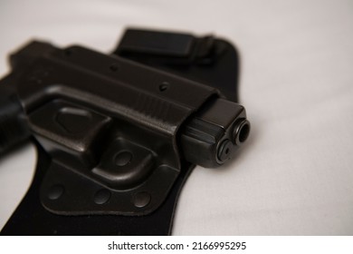 A handgun is seen inside of a concealed carry holster. 