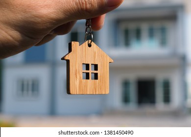 Hand-held key chain image The back has a sample house. - Shutterstock ID 1381450490