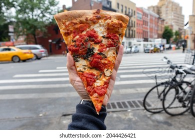 Handheld New York Style Margherita Pizza Slice On A New York City Street