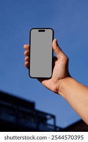 Hand-Held Smartphone Mockup with Clear Blue Sky Background