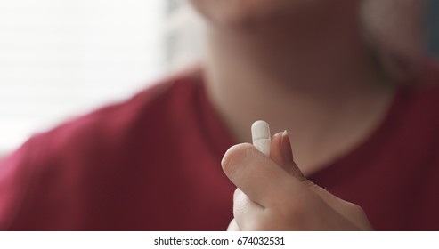 Handheld Teen Girl Taking Pill