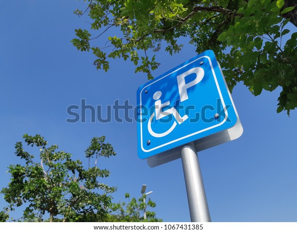 handicap sign board ramp up and park for\
disable clear blue sky \
background