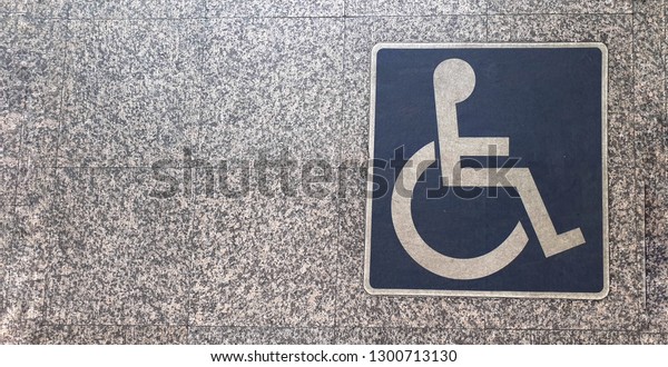 Handicap\
sign on floor. Special lane for disabled\
people.