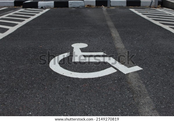 Handicap sign on the\
parking lot surface