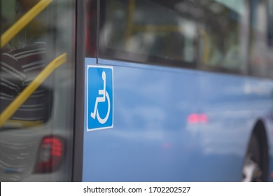 handicap sign on side of bus near door
