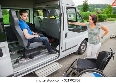 Handicapped boy is picked up by school bus - Shutterstock ID 321992786
