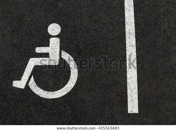 Handicapped disabled people parking lot sign for\
car wheel chair\
asphalt