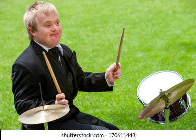 Handicapped Drummer Boy Playing Drums Outdoors.