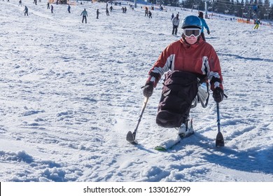 Handicapped Man Riding A Mono Ski From The Snow Mountains, Adaptive Skiing For Disabled Men, Vacation In The Mountains For Wheelchair 