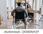 Handicapped man in wheelchair rolling his wheelchair, joining his lovely, female coworker for a teamwork.