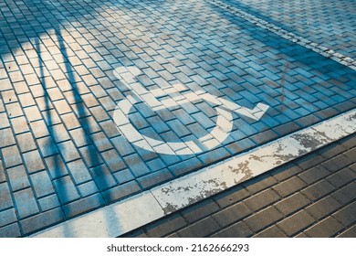Handicapped parking bay. Reserved parking sign for disabled spaces disabled blue parking sign painted on dark asphalt Disabled sign at a parking lot