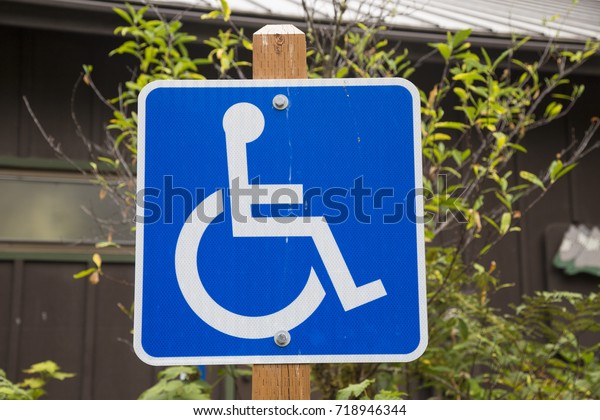 Handicapped parking sign\
blue wheel chair