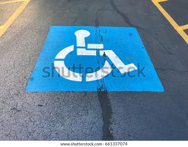 Handicapped parking sign on a parking lot / With\
Copy Space