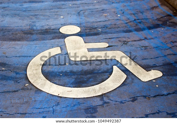 Handicapped\
parking spot. Blue background and white\
sign.