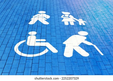 Handicapped parking spot, mom with child, elderly person and man with plaster. blue square on asphalt.