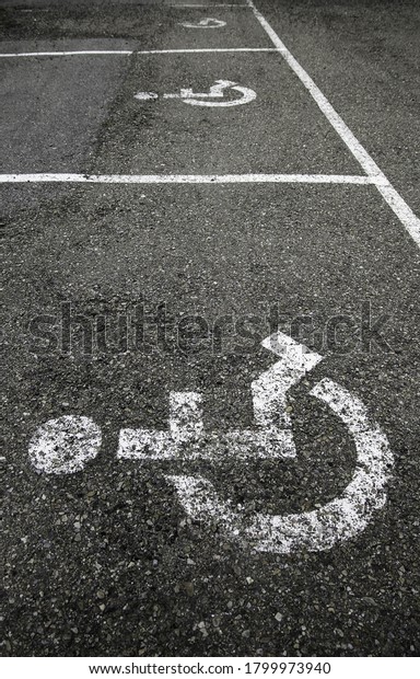 Handicapped sign on the asphalt, information\
for disabled people, facilities for\
people
