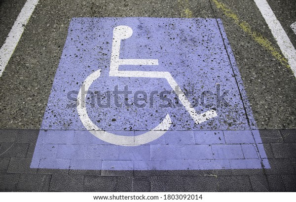 Handicapped sign on the asphalt, information\
for disabled people, facilities for\
people