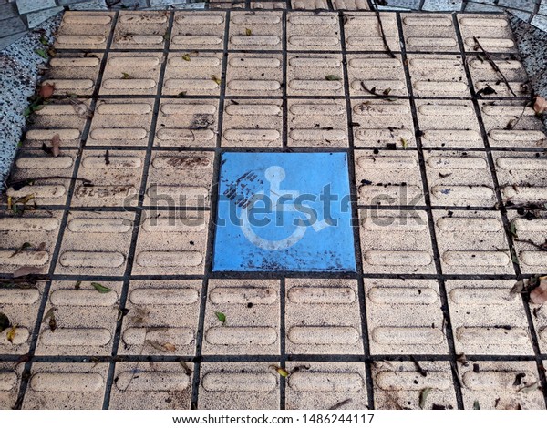 Handicapped sign on the\
ground in the park