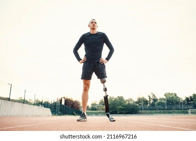 A handicapped sportsman standing at stadium and taking a break. - Powered by Shutterstock