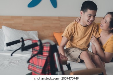 Handicapped Teenager Boy On Wheelchair Looking His Mother With Happy Face, Parental Care For Physical And Mental Health Of Child With Disabilities, Health And Medical Concept.