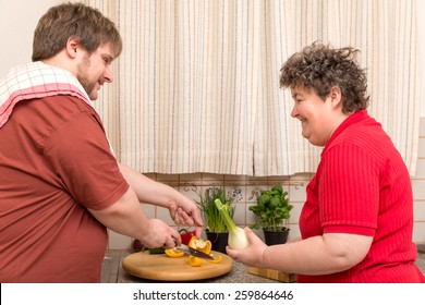 a handicapped woman and a young man in the kitchen