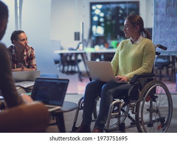 Handicapperd Businesswoman In A Wheelchair On Meeting With Her Diverse Business Team Brainstorming At Office