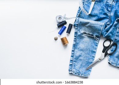 Handicraft, clothing repair. Ripped blue jeans sewing accessories white background. The concept of economical things. - Shutterstock ID 1663884238