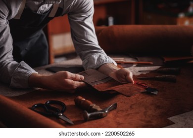 Handicraft production, Craft man tailor checks handmade brown leather product. - Powered by Shutterstock