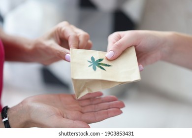 Handing Over Paper Bag With Marijuana Sign. Marijuana Delivery Service Concept