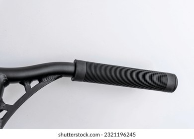 the handle bar of a stunt scooter with black rubber comfortable grips, a stunt scooter, equipment for extreme skating in a skatepark and on a ramp. Details of the scooter. Repair, rental and sale 