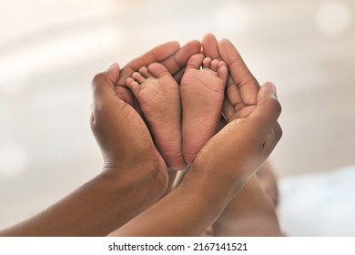 Handle with care. Cropped shot of a mother holding her babys feet. - Powered by Shutterstock