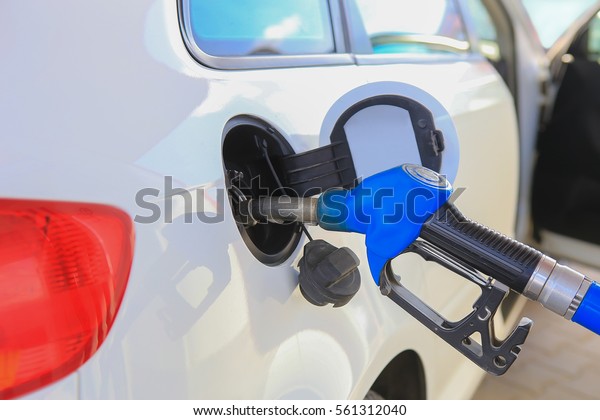 handle of the\
filling gun in car gasoline\
tank