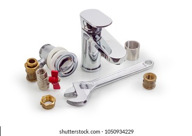 Handle mixer tap, several brass and steel pipe couplings, adapters, drain, nuts, ball valve and adjustable wrench on a white background