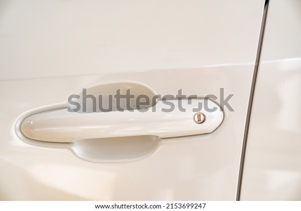 the handle on the door on the white car.\
purchase and sale of modern cars in official dealerships and auto\
shops. sale of auto parts.\
maintenance.