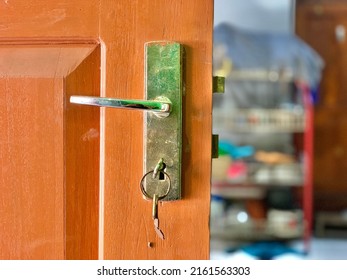 Handle Wooden Door And Key Lock With Soft Focus Kitchen Set Background