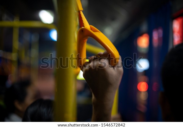 The\
handles on the yellow-orange bus car and bokeh\
lights