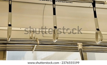 handles for standing passenger inside skytrain in japan