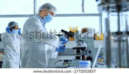 Handling scientist preparing samples at lab bench, wearing white lab coat, using microscope. Research, bioscience, analytical, collaboration, benchtop, glassware, windows