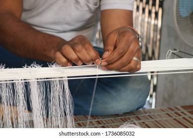 A Handloom Weaver Preparing His Loom In India.