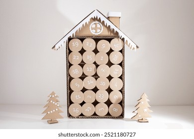 handmade advent calendar craft made of empty toilet paper rolls, DIY, step 4, top view, blue background - Powered by Shutterstock