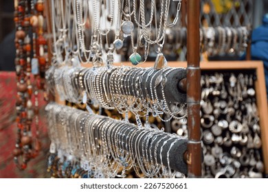 Handmade artisanal jewelry and accessories on display at a street market