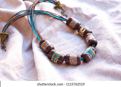 Handmade beaded tube necklace. Polymer clay jewellery. Still life boho style.