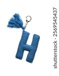 Handmade blue crochet letter "H" keychain with a tassel, isolated on white background, perfect for personalized gifts or accessories.